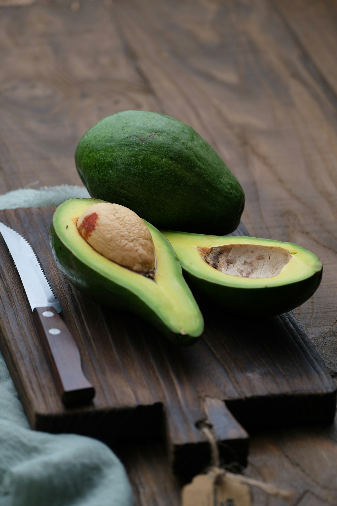 Avocados slices with wooden board and knife